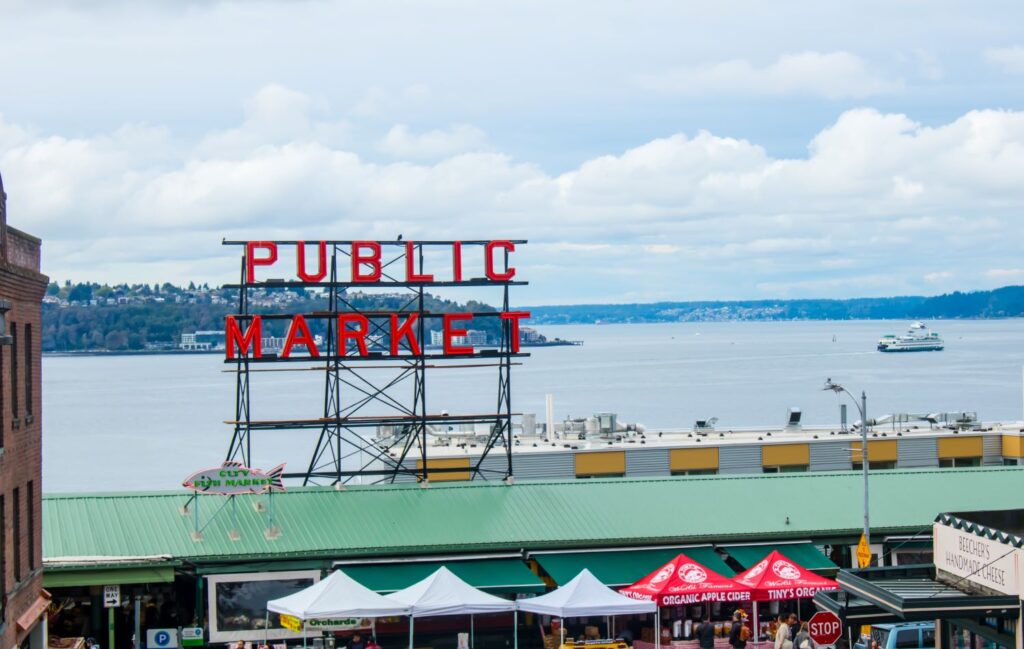 Iconic Public Market sign overlooking Elliott Bay and market stalls at Seattle’s Pike Place Market