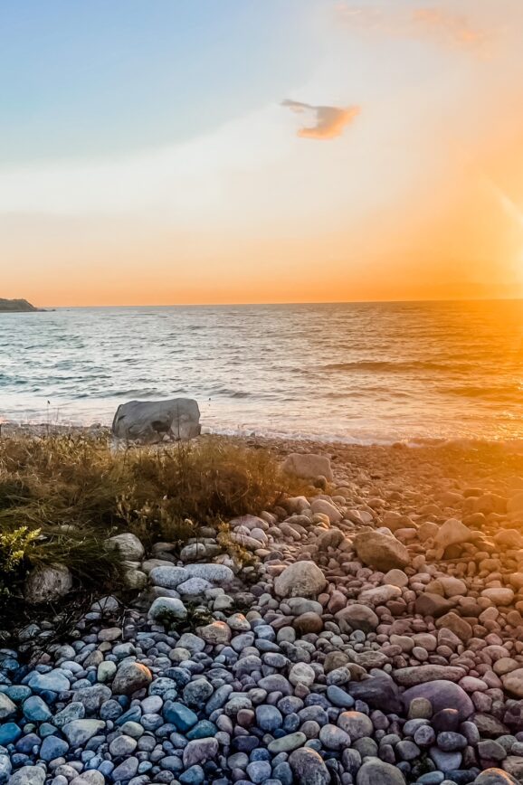 Golden sunset over the rocky shore at Churches Beach on Cuttyhunk Island.