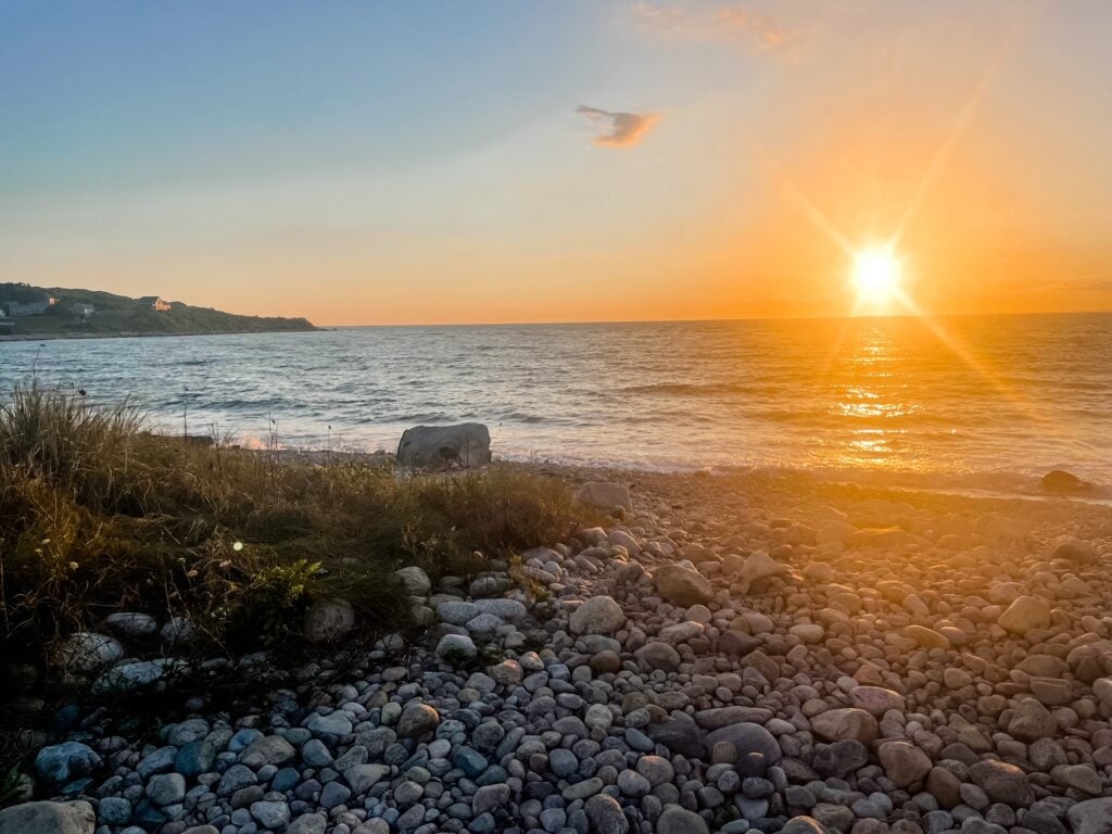 Golden sunset over the rocky shore at Churches Beach on Cuttyhunk Island.