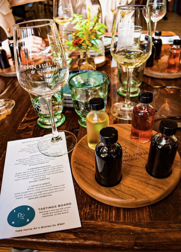 Wine tasting setup with glasses and sample bottles at Pippin Hill Farm & Vineyard.