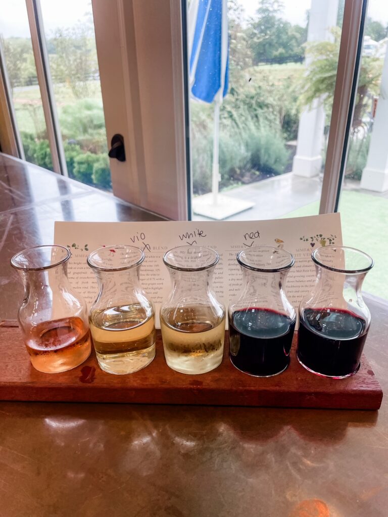 Wine tasting flight with rosé, white, and red wines at Merrie Mill Farm & Vineyard.