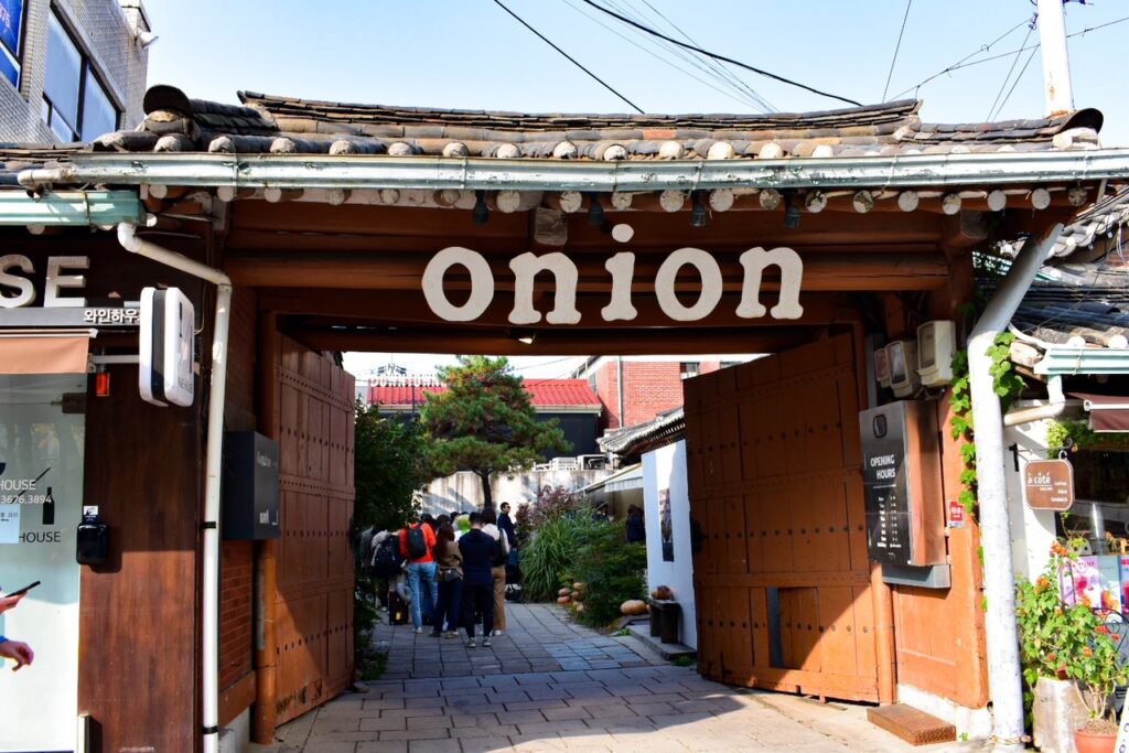 Traditional wooden gate entrance to Onion Anguk café in Seoul.