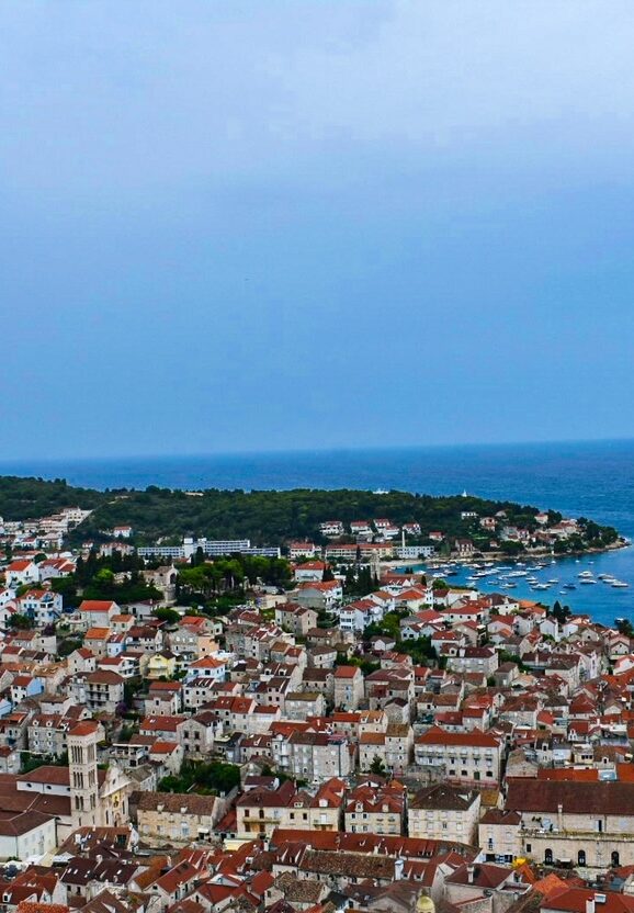 Panoramic view of coastal Croatia with red-roofed buildings and the Adriatic Sea in the background