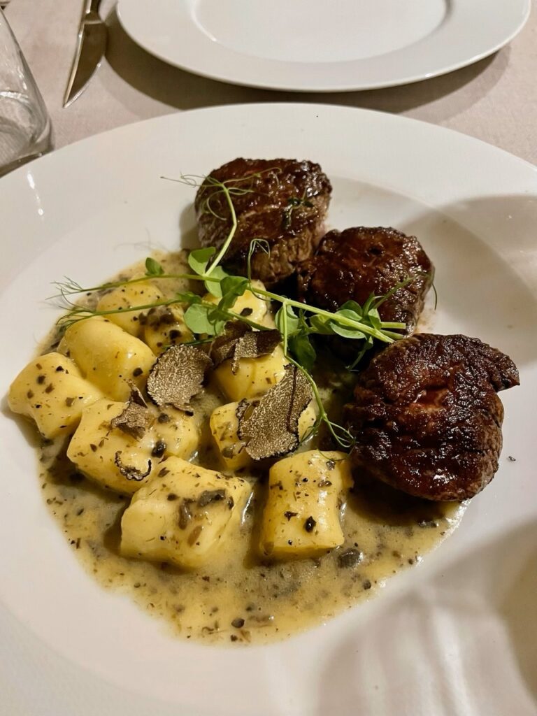 Truffle gnocchi with tender beef medallions in creamy sauce.