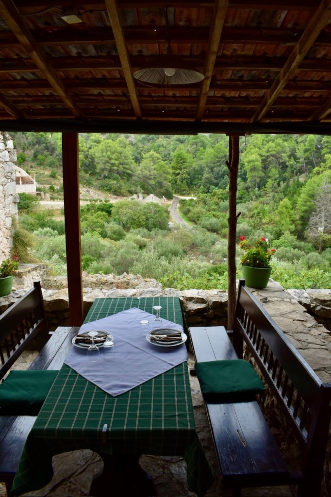 Rustic outdoor dining area overlooking lush Croatian hills.