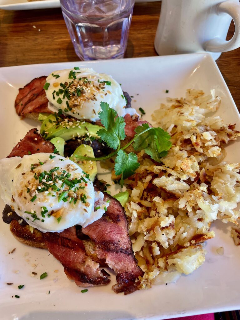 Avocado toast with poached eggs, turkey bacon, and hash browns at Café Pasqual’s in Santa Fe