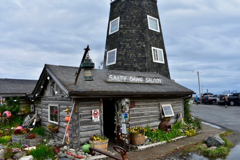 Exterior of the historic Salty Dawg Saloon on the Homer Spit in Homer, Alaska, featuring its signature lighthouse-style structure