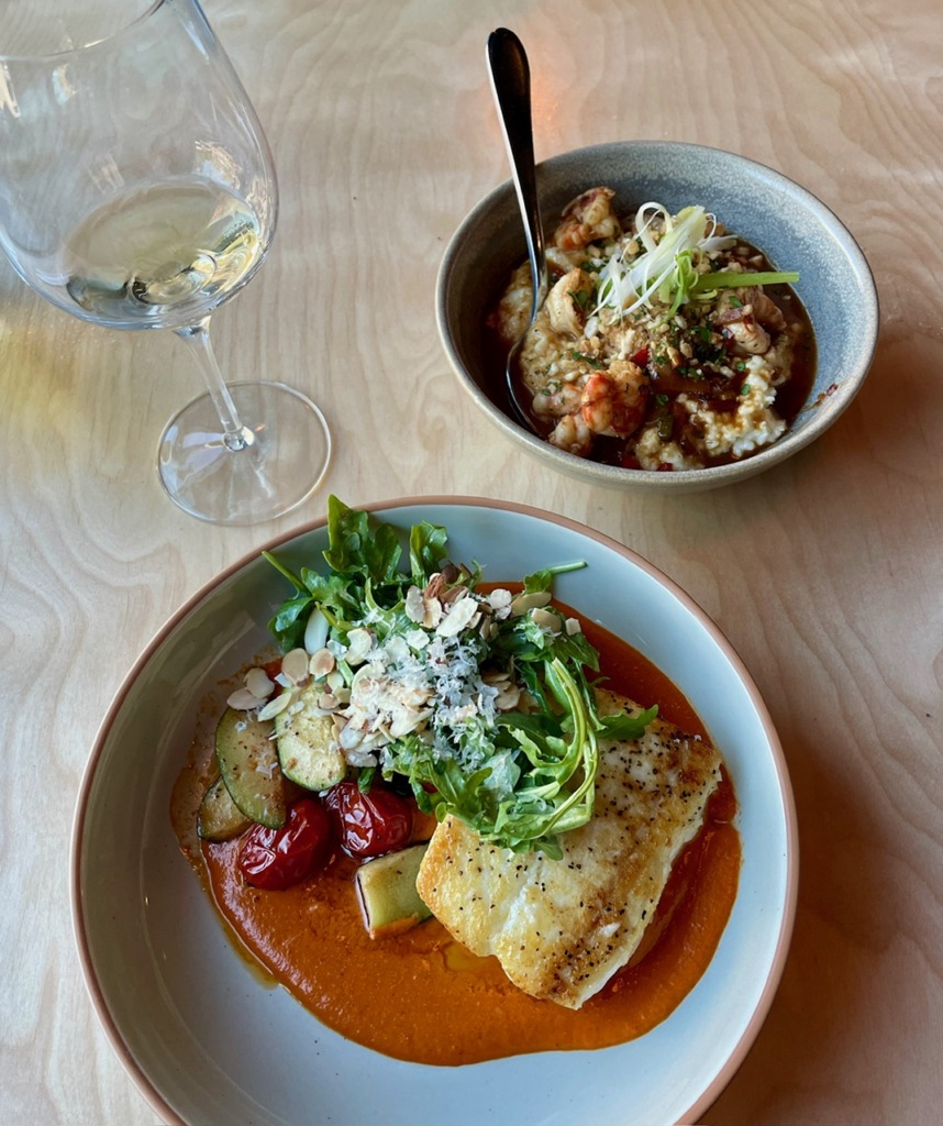 Halibut dish with roasted tomatoes, arugula, and red pepper sauce at The Cookery restaurant in Seward, Alaska