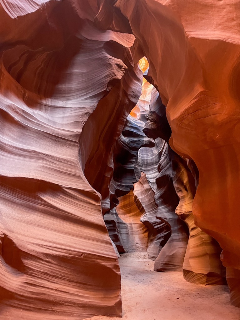 Curved red sandstone walls at Antelope Canyon illuminated by soft natural light in northern Arizona